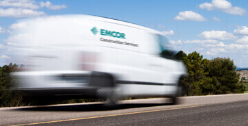 EMCOR Construction Services van driving on the road
